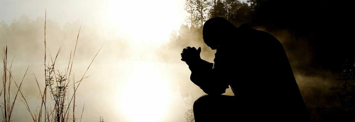 Man kneeling in prayer