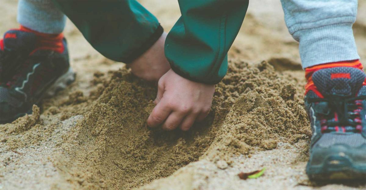 boy digging in sandbox