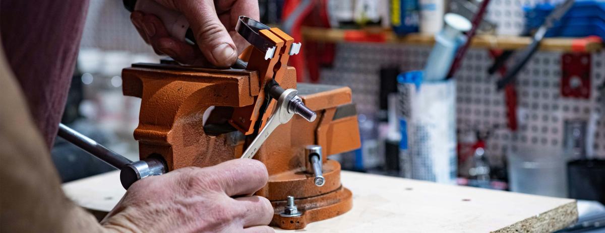 Man using a vise in his workshop